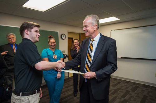 Zach Mandell, left, presents Sen. Jerry Moran (R-Kansas) with an honorary membership to Emporia Men’s Assembly of Nursing, a chapter of the American Assembly of Men in Nursing, during Moran’s visit Feb. 16 to the Department of Nursing.
