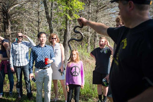 Dr. Brent Thomas, biologist and dean of the College of Liberal Arts and Sciences, shows a snake to a group during a tour at the Ross Natural History Reservation.