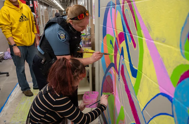 Officer painting mural