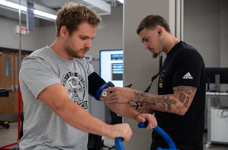 Students practicing blood pressure measurement in the Doc Baxter Lab